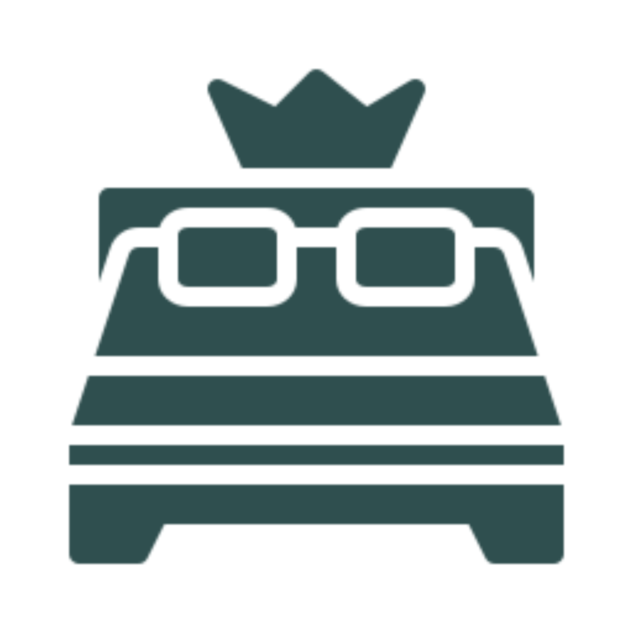 Bed with a pair of glasses and a crown on top of it, set against a white background