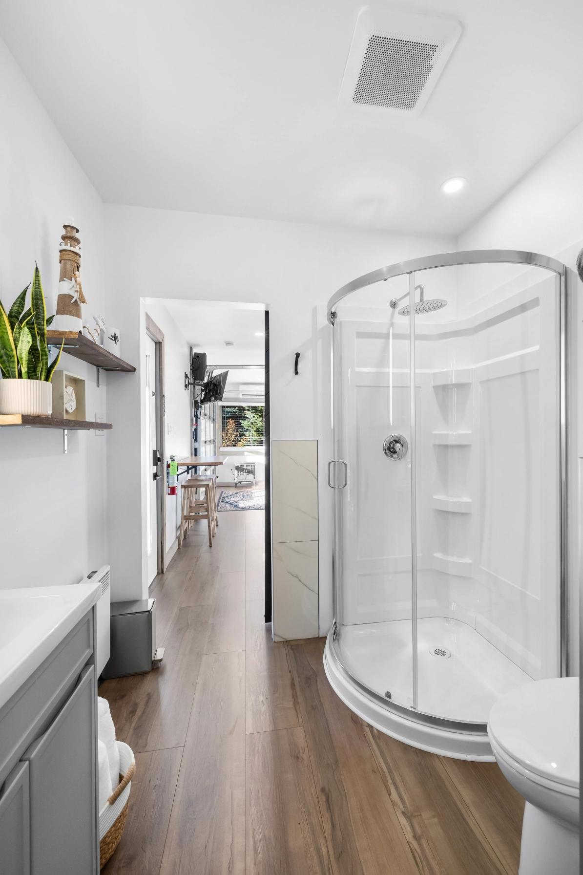 White bathroom with plants and nautical decor