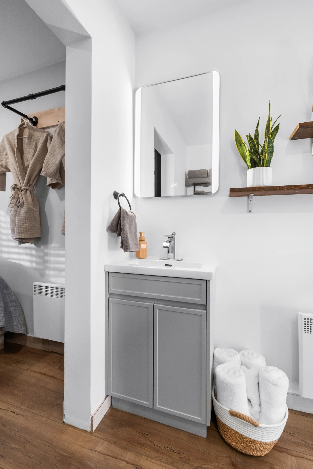 Modern bathroom vanity with mirror and plant