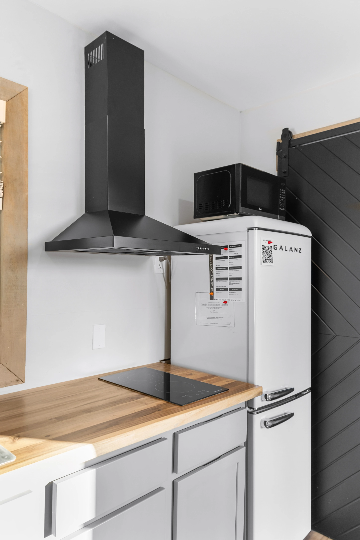 White refrigerator, black hood, and microwave