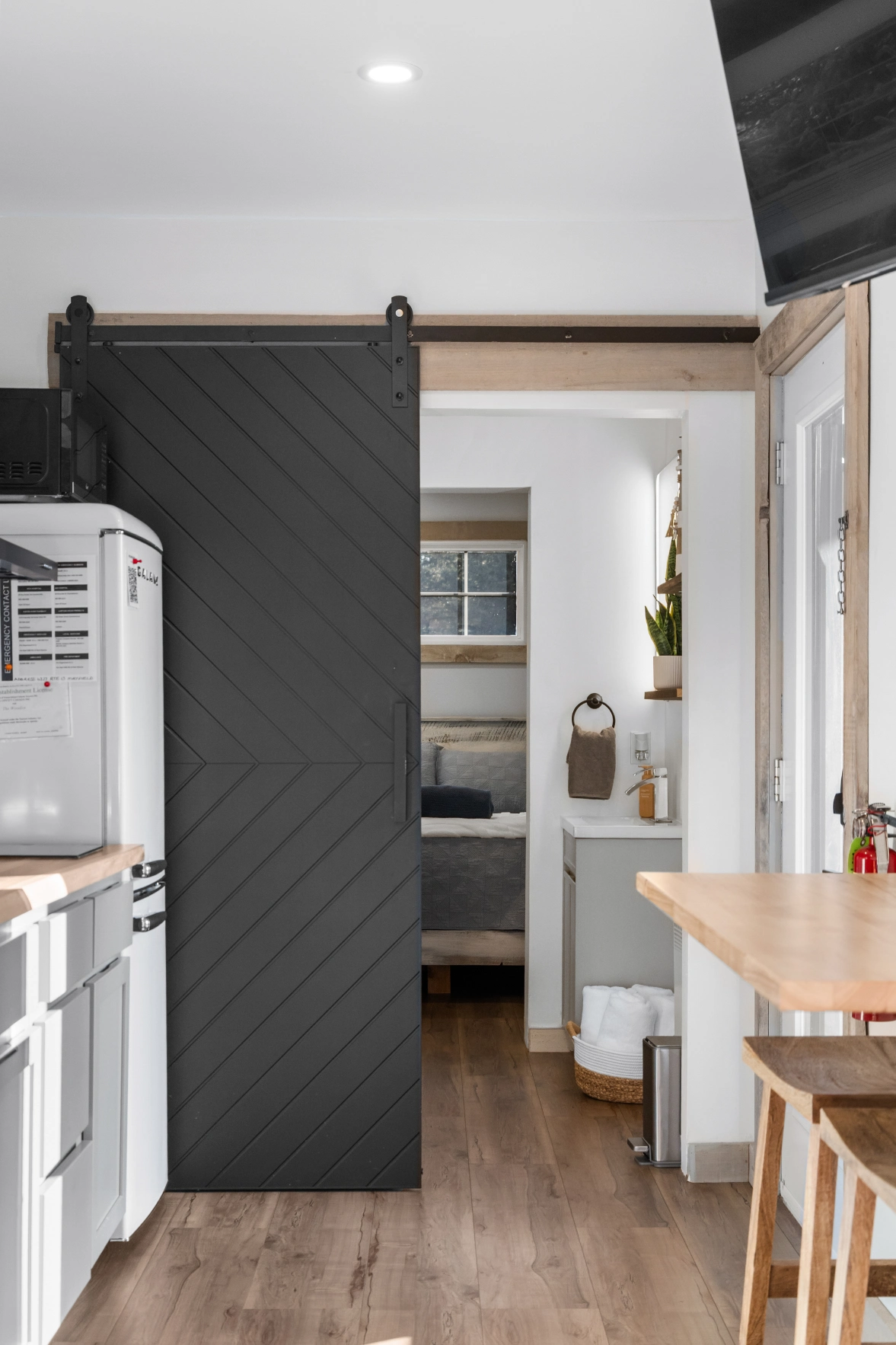 Contemporary interior design with wood flooring and barn door