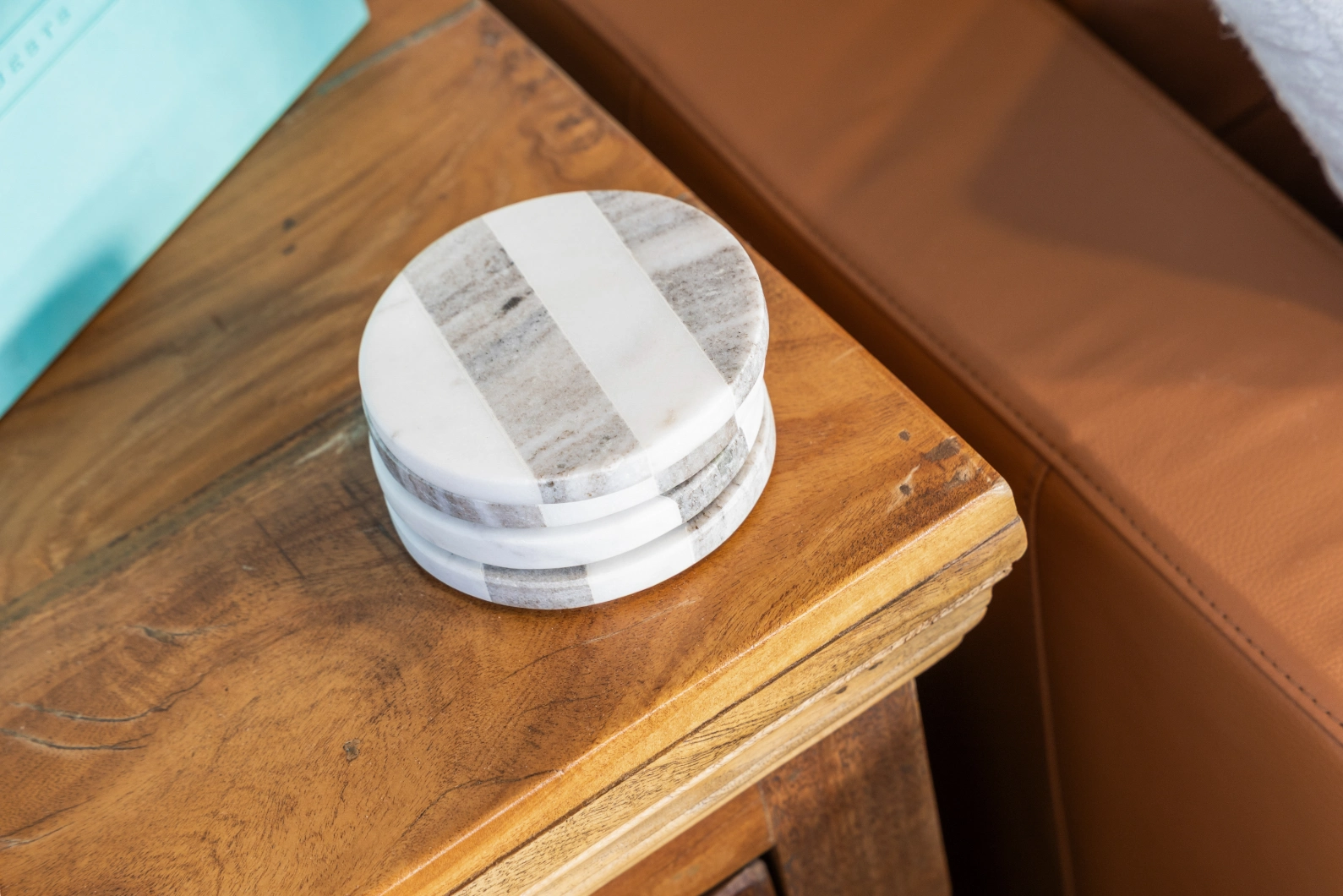 Decorative coasters on wood side table