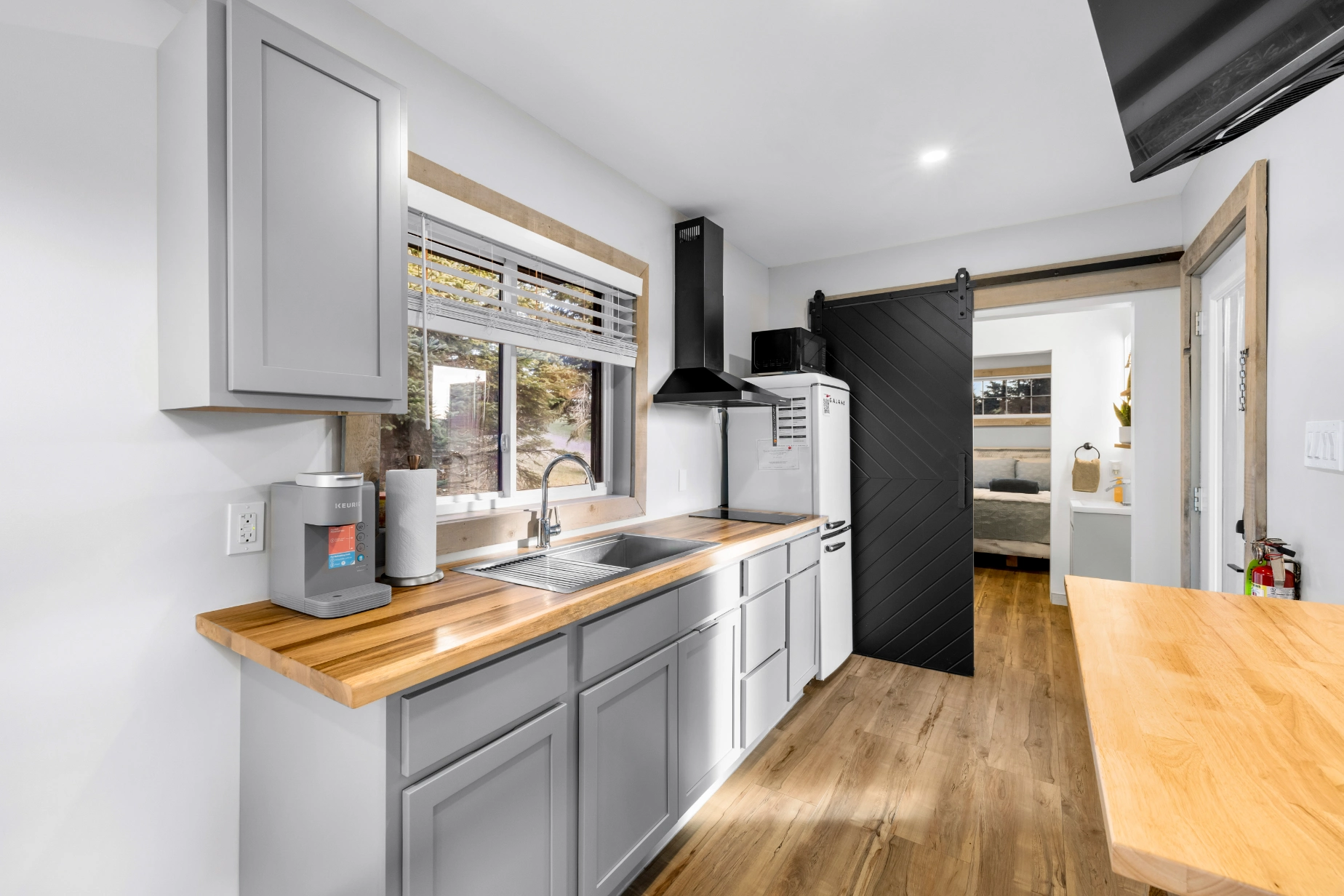 Modern kitchen with wooden counters and gray cabinets.