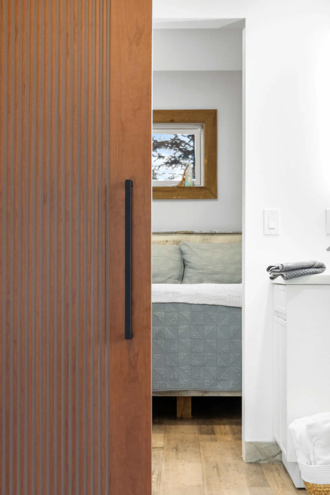 Modern bedroom with natural wood door