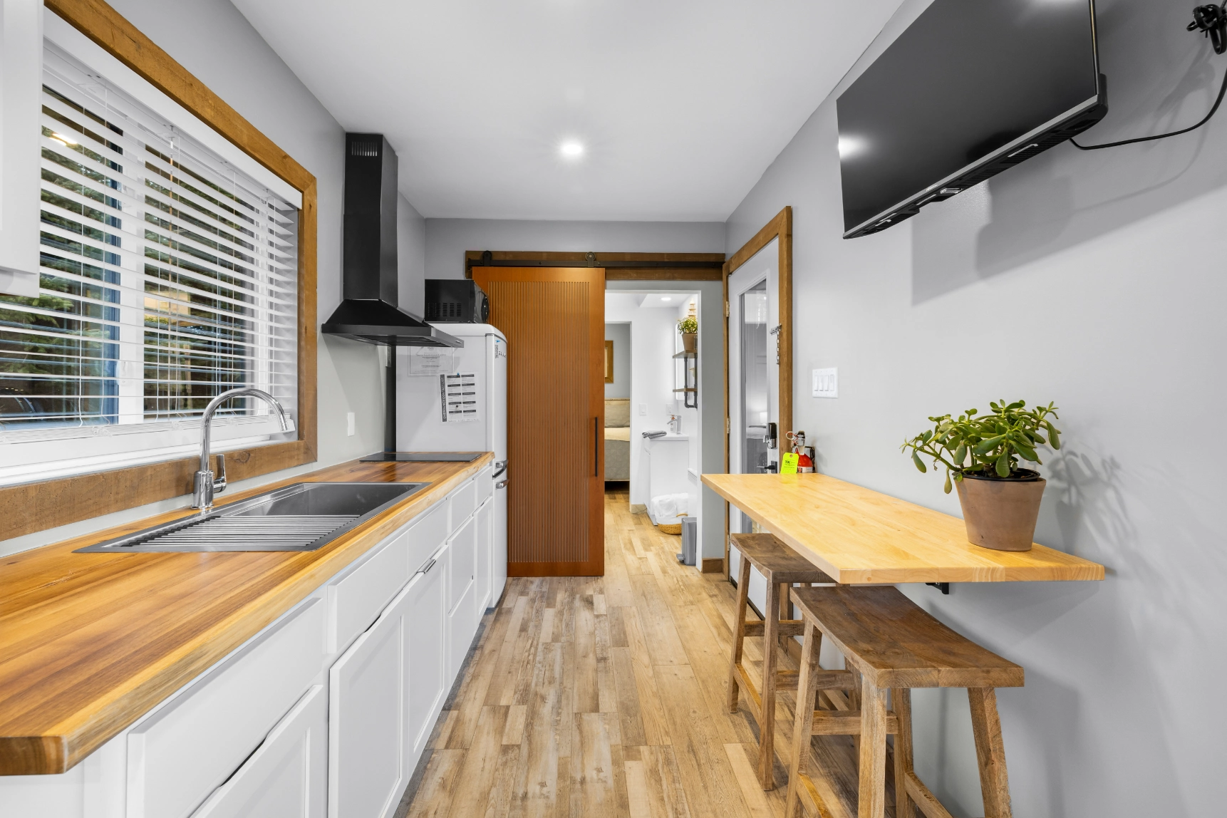 Compact kitchen with wood flooring and sink