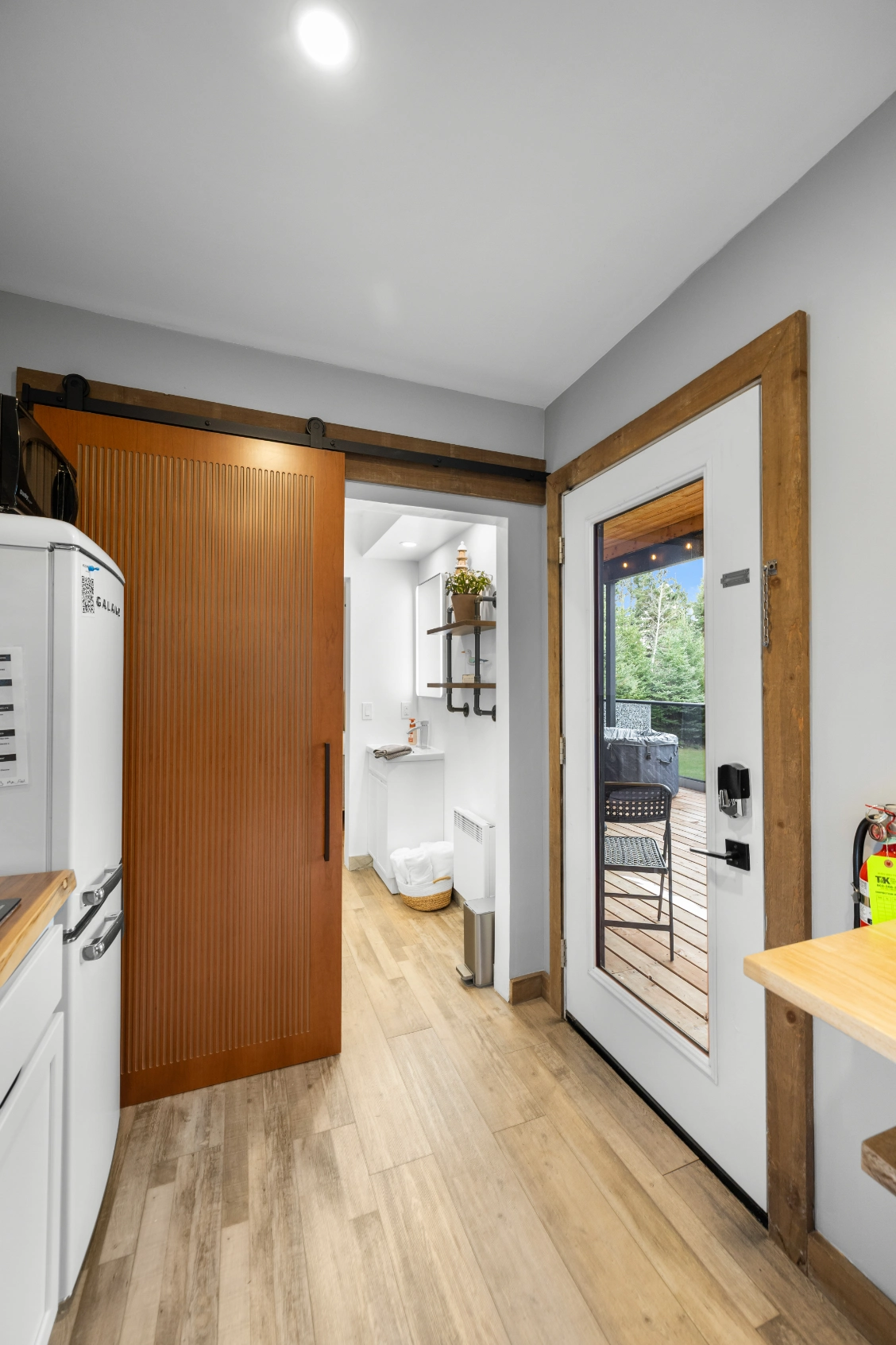 Interior view of kitchen, bathroom, and deck