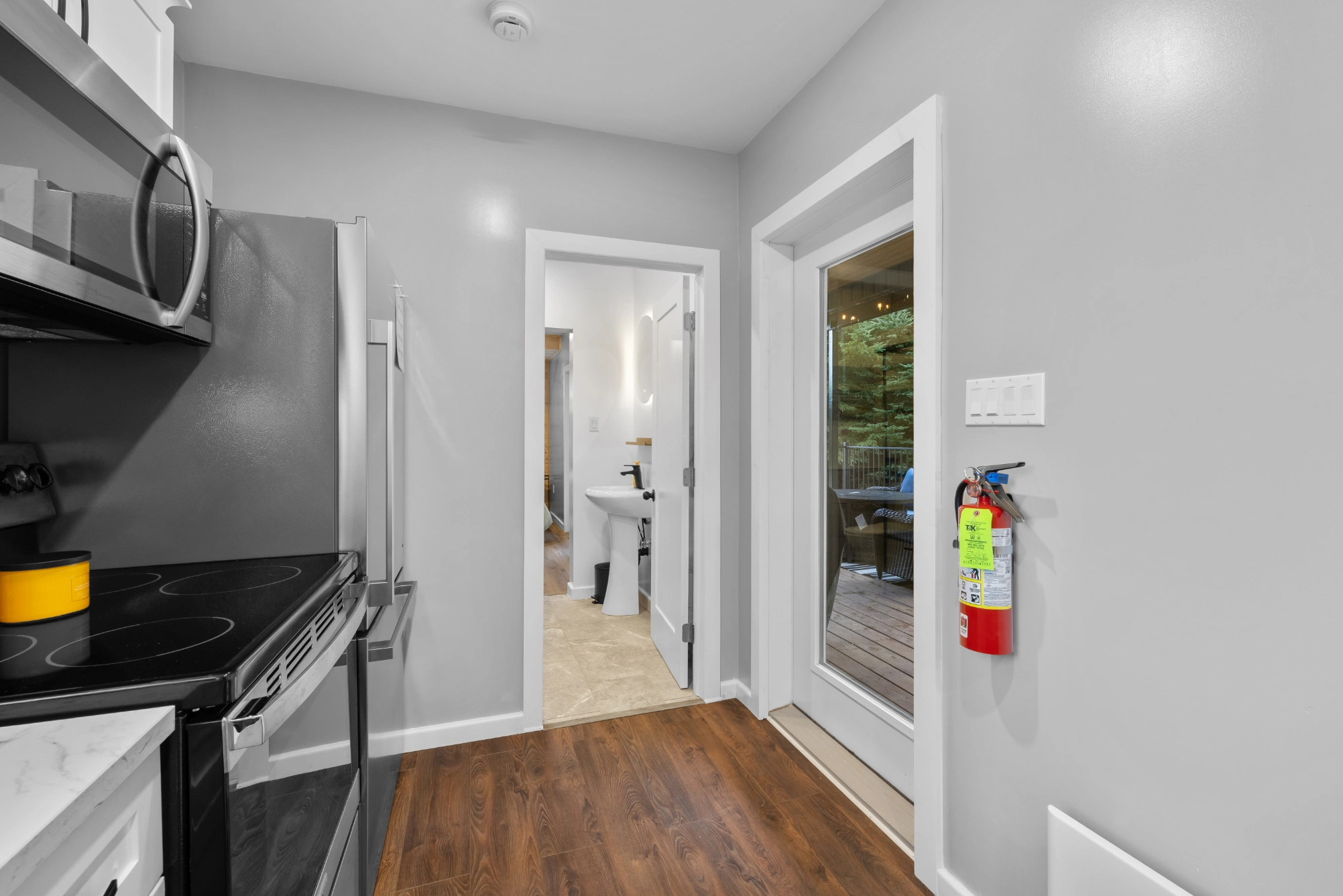 Contemporary kitchen leading to bathroom and outdoor deck