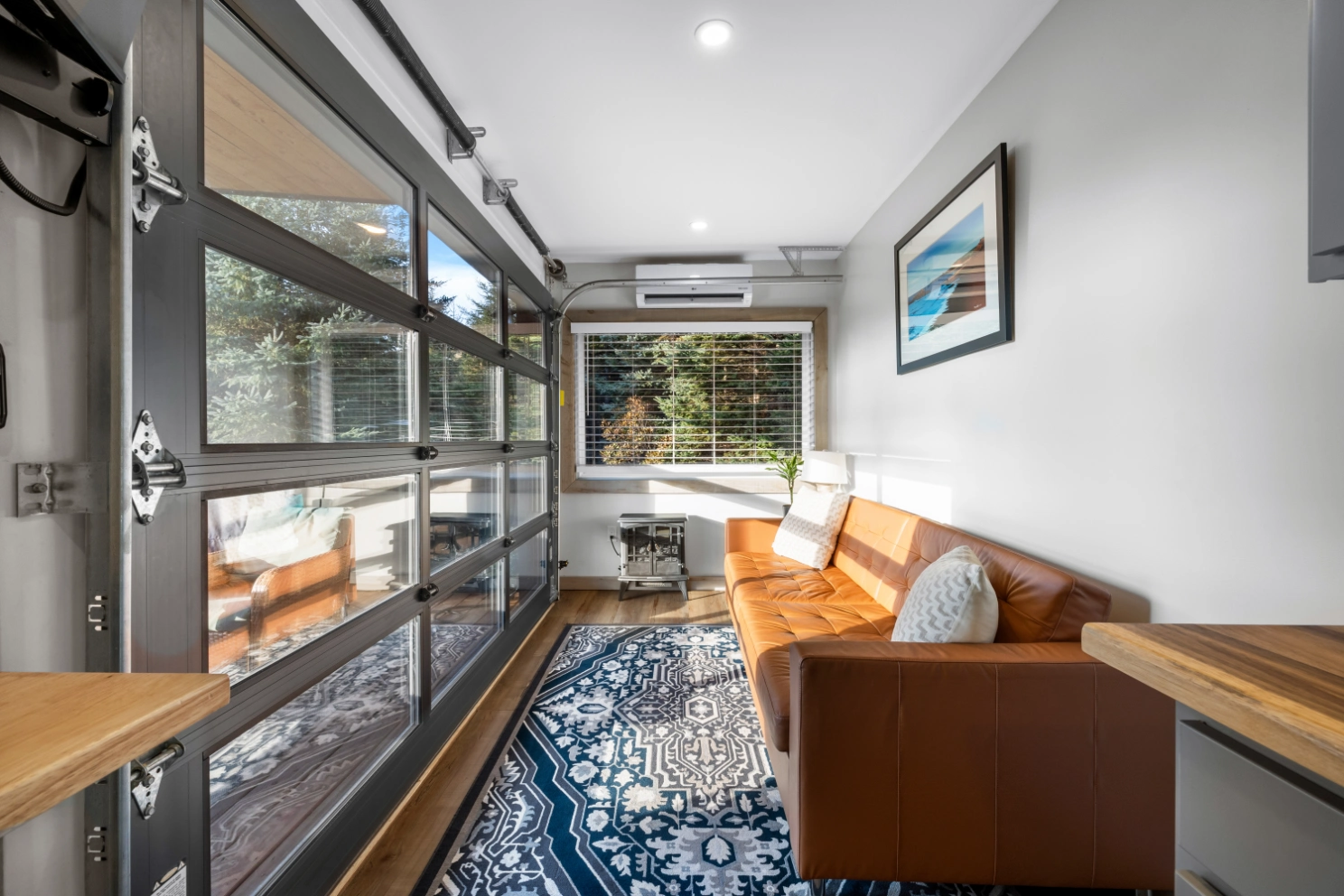 Stylish interior with blue rug and large window