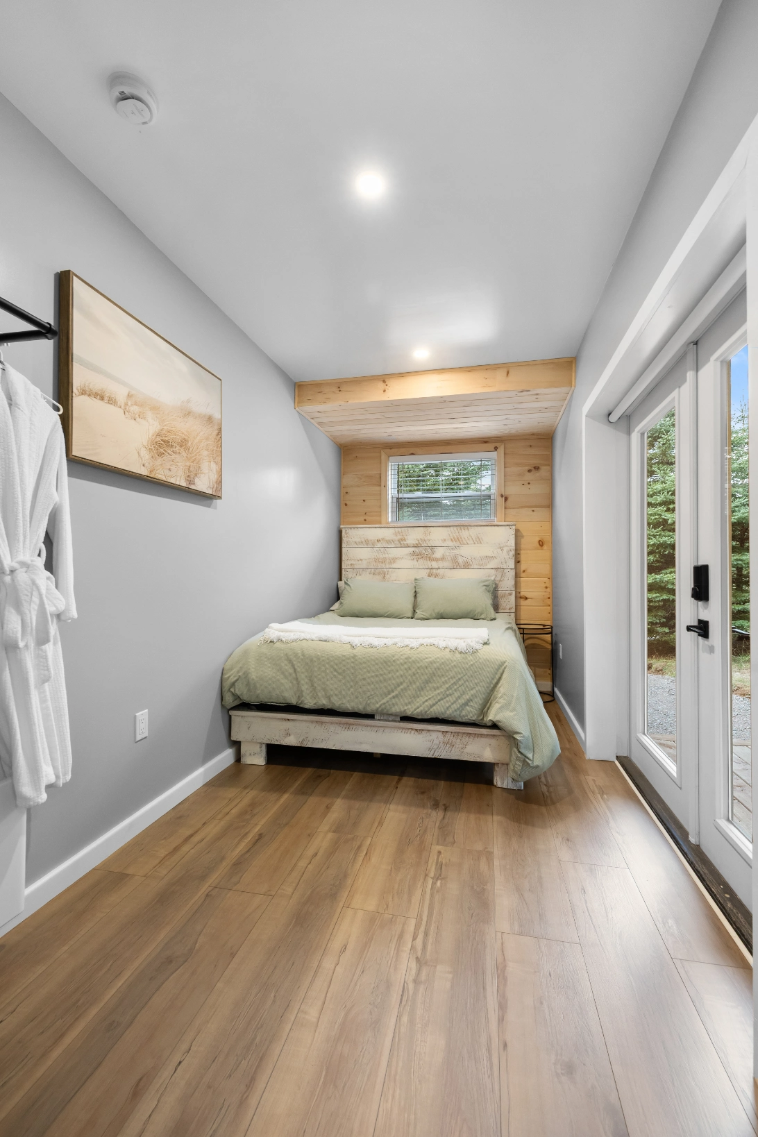 Cozy bedroom with green bedding and wood accents