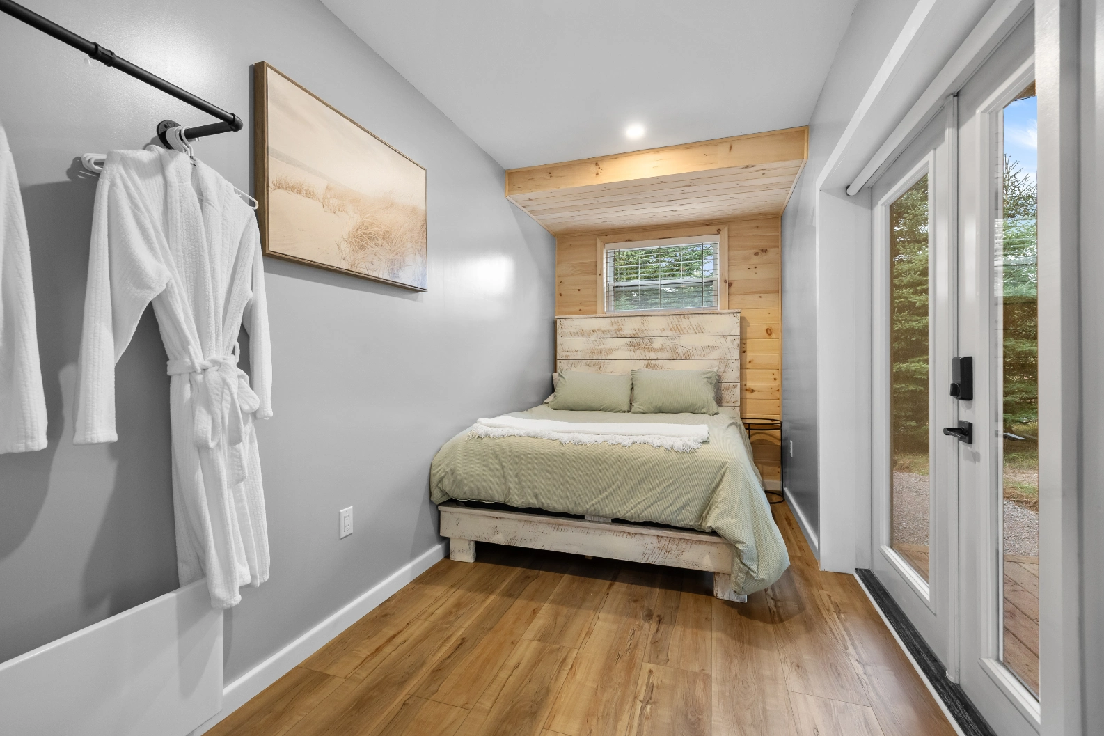 Small bedroom with green bedding and window