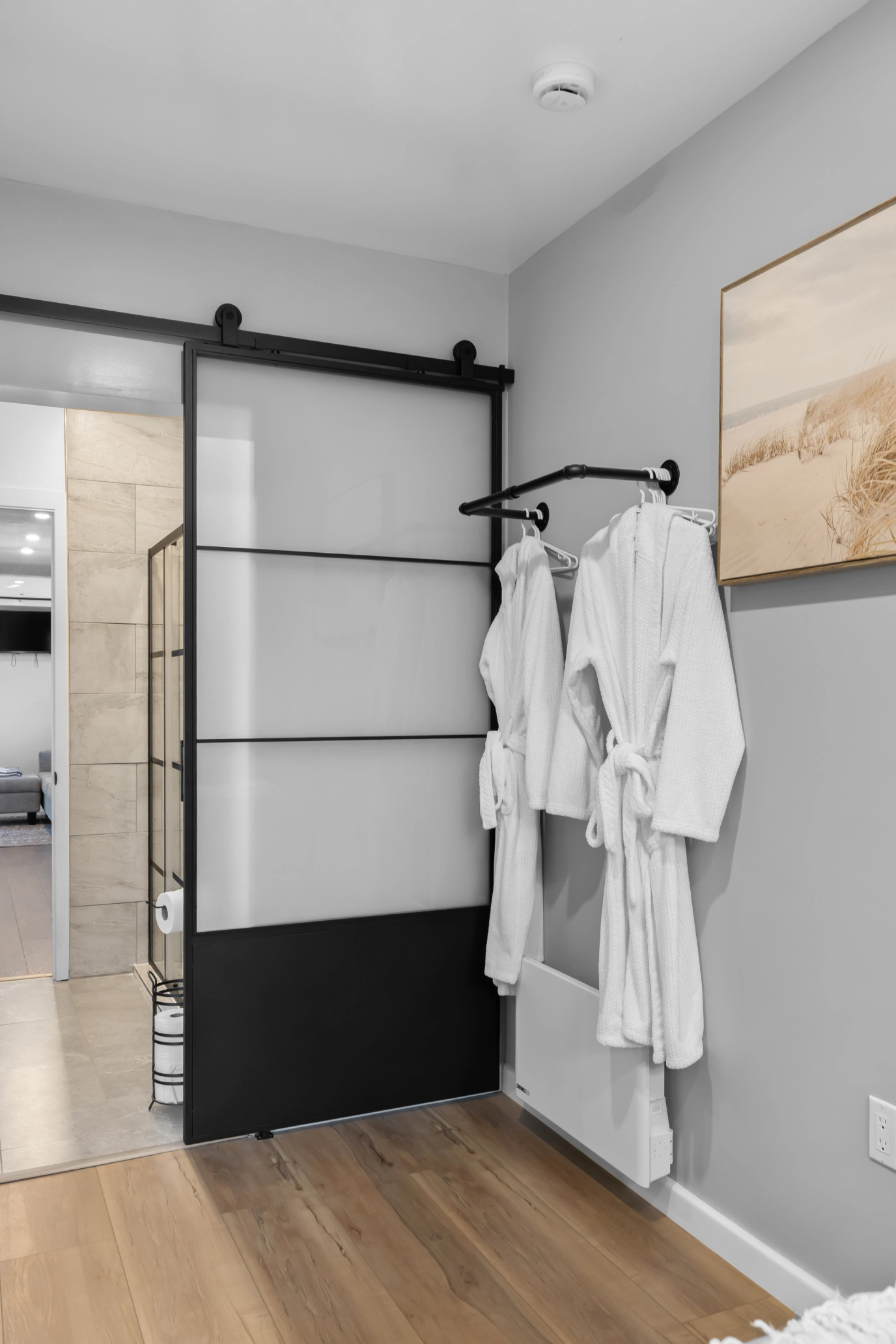 White bathrobes hanging in stylish bathroom