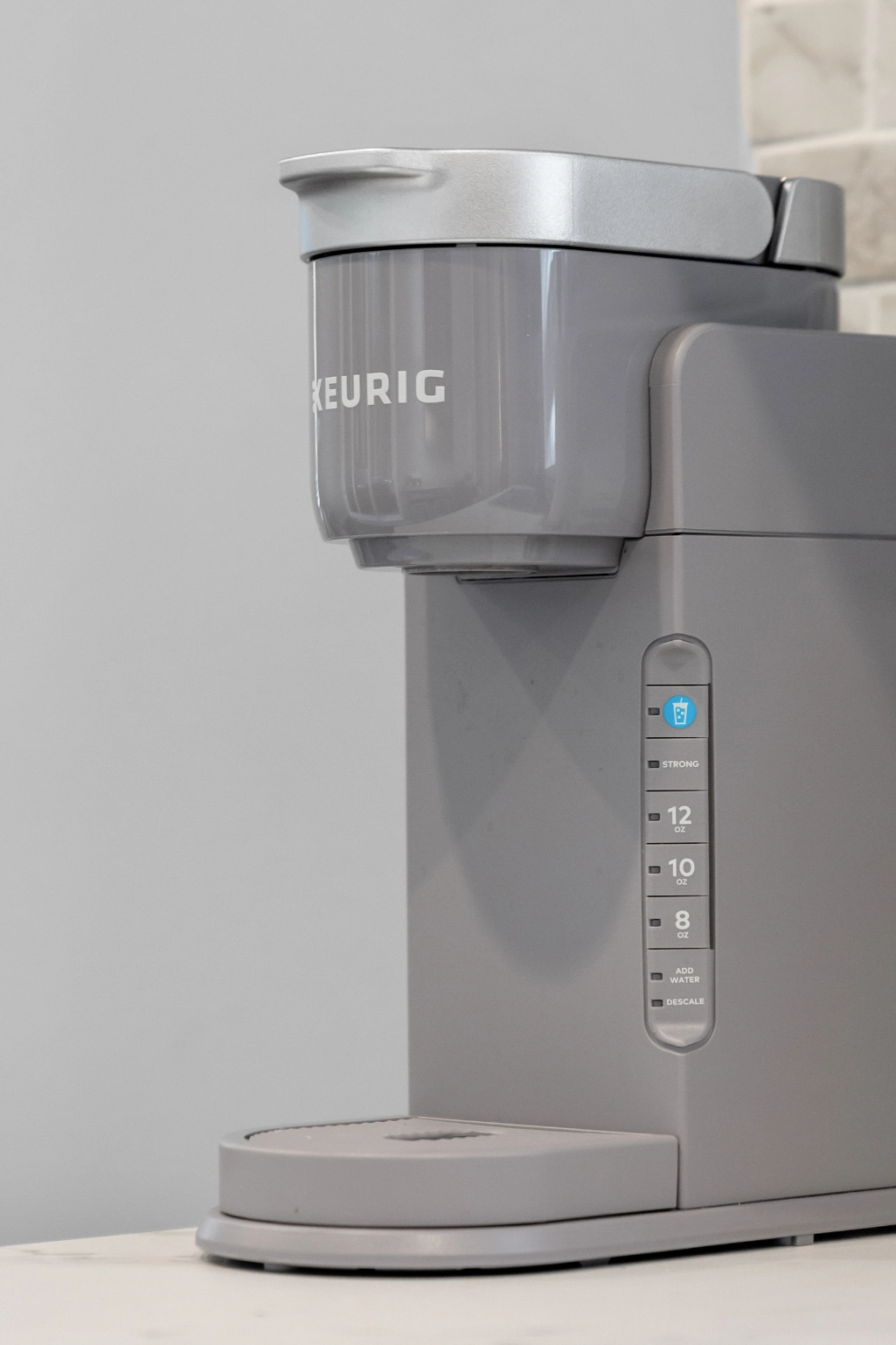 Keurig coffee brewer with illuminated cup icon