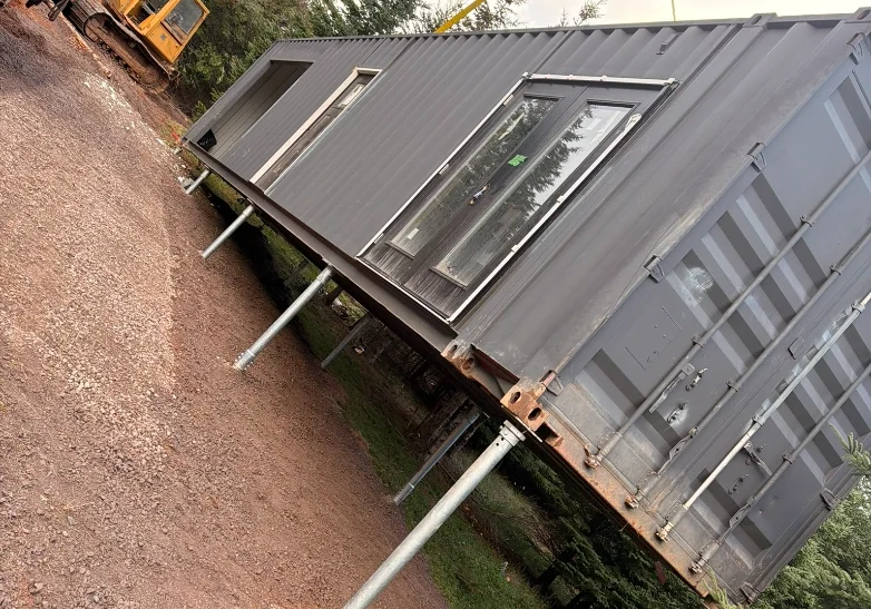 Container home installation with support posts